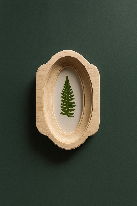 Wooden frame with a pressed fern on a dark green background