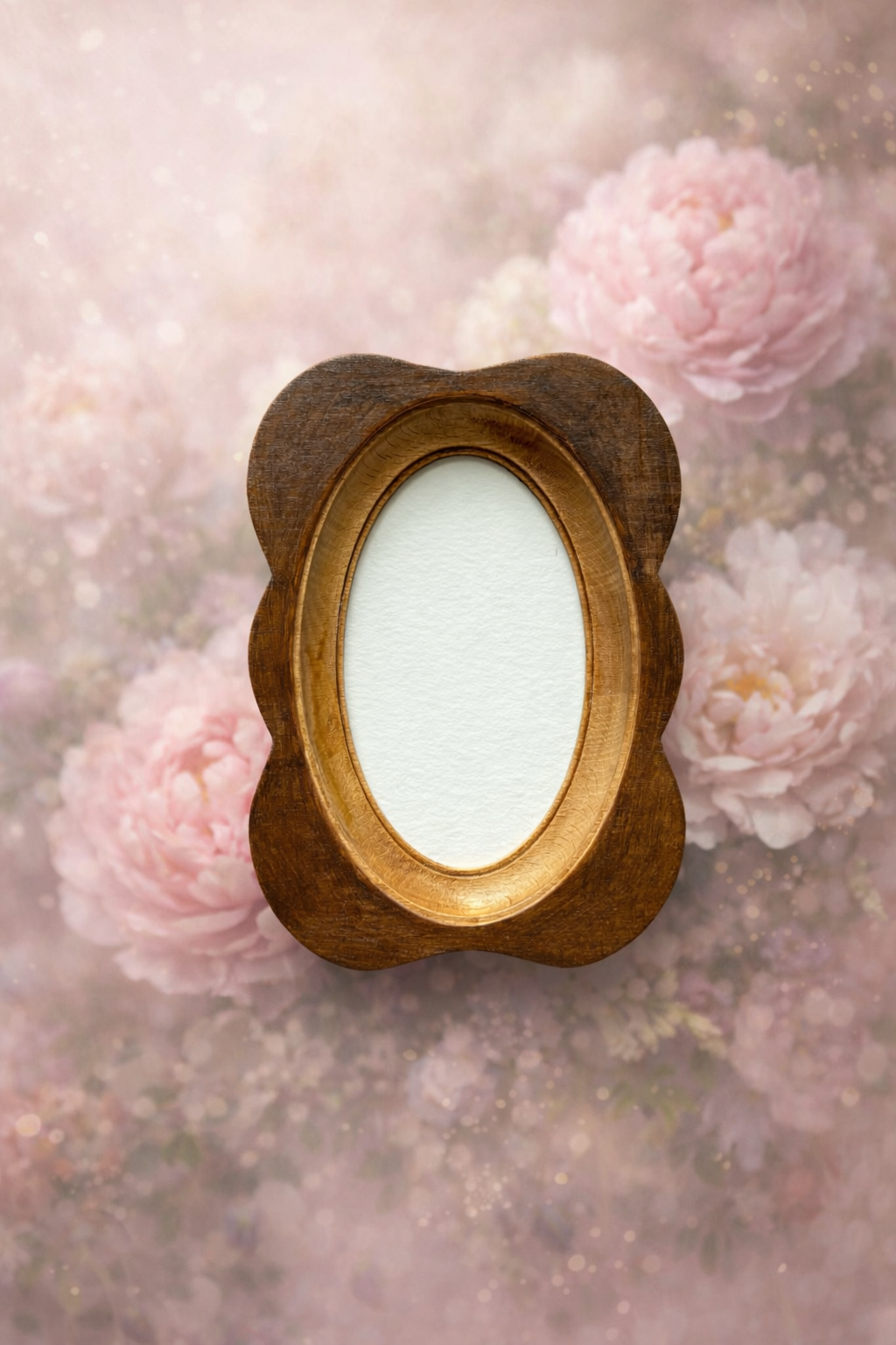 Wooden oval frame with a white center against a soft floral background