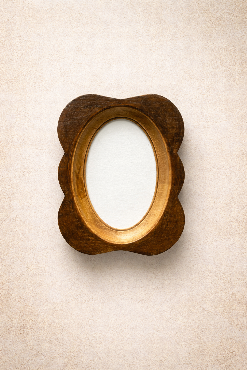 Wooden frame with a scalloped edge on a beige wall