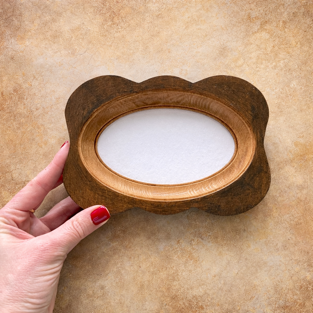 Wooden frame with a circular cutout held by a hand on a beige background