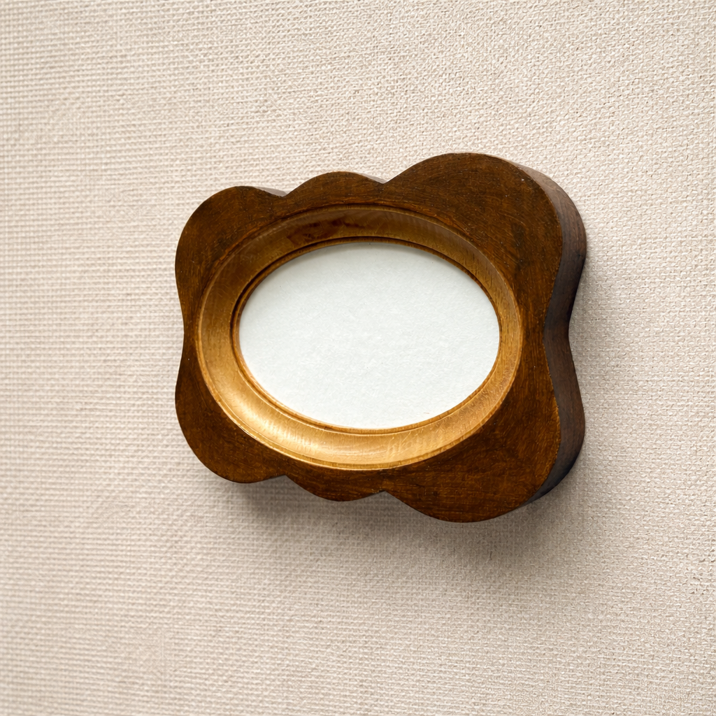 Decorative wooden frame with a circular cutout on a beige background