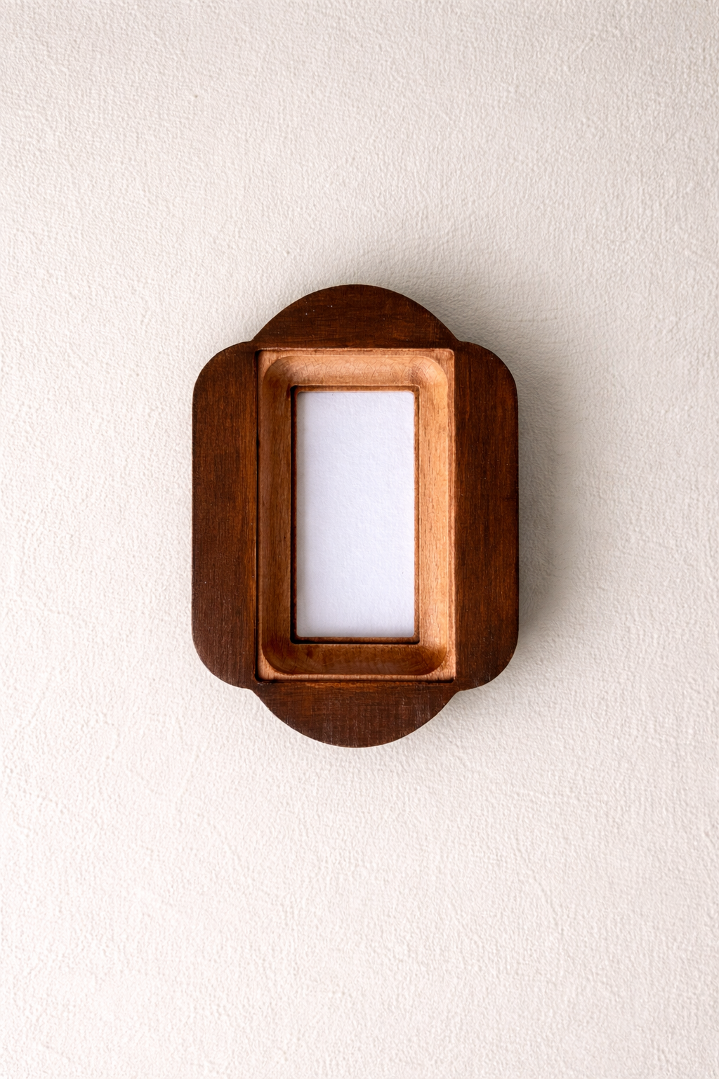 Wooden picture frame on a white wall