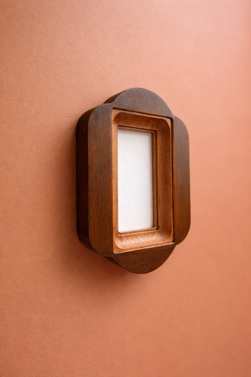 Wooden frame with a white square inside on a brown background