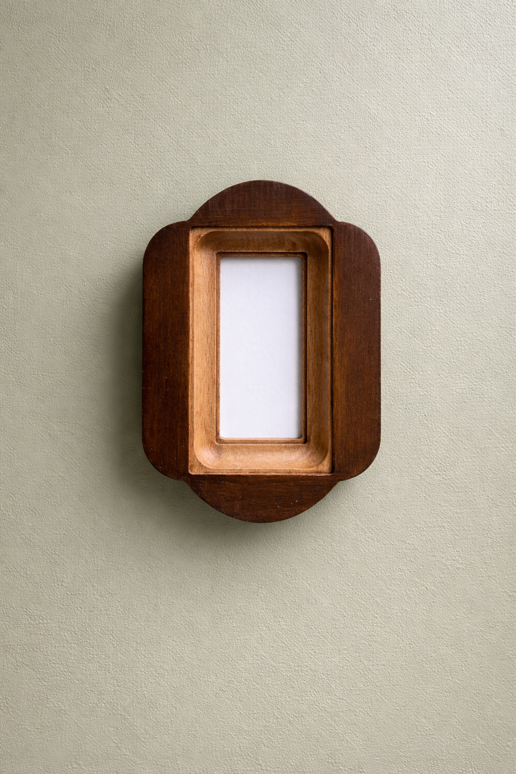 Wooden picture frame on a beige wall