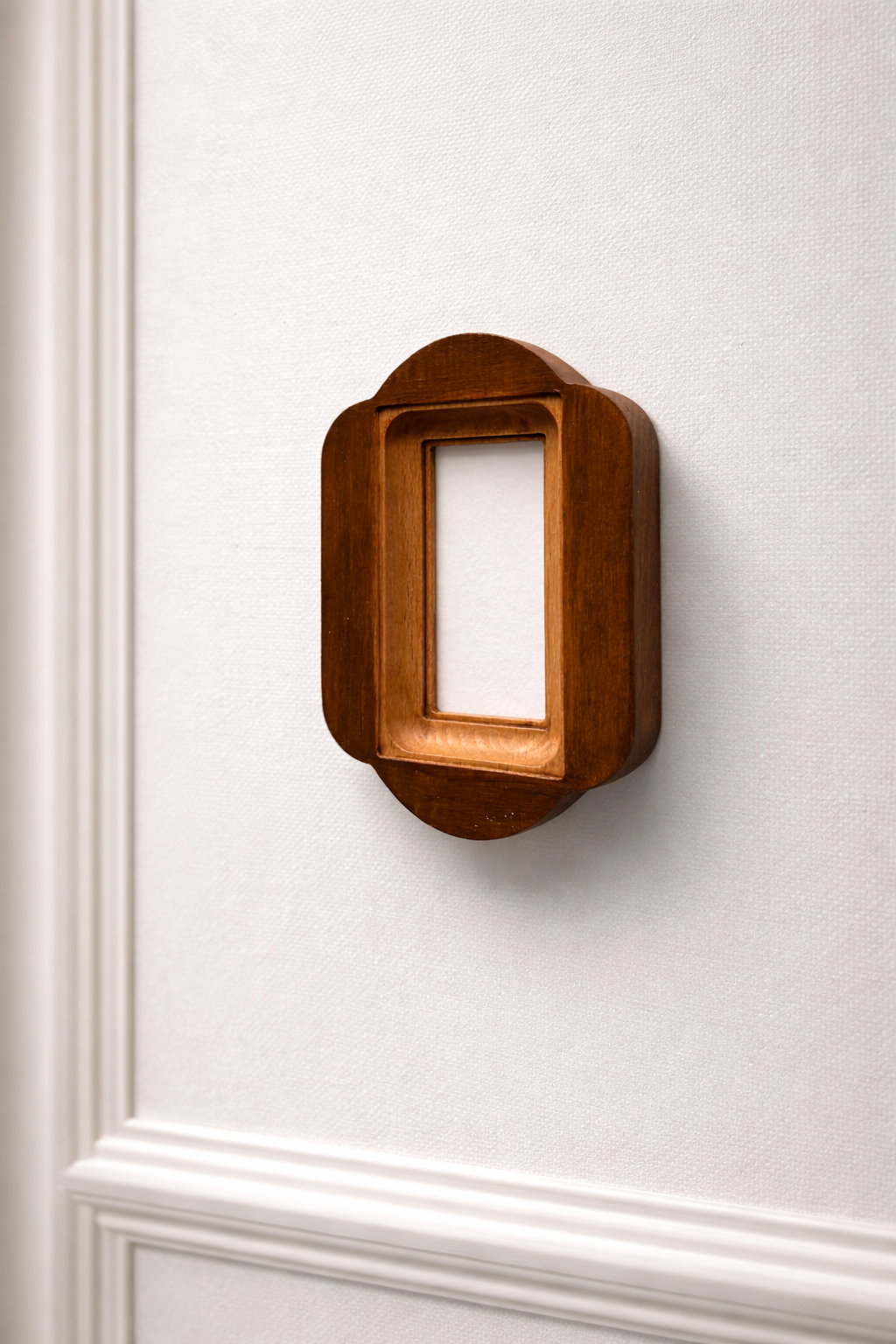 Wooden wall-mounted frame on a white wall