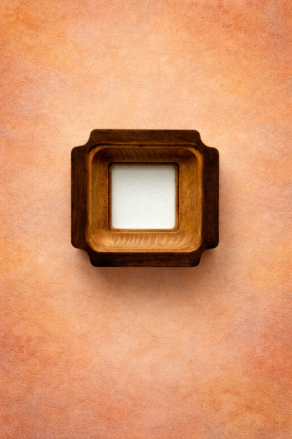 Wooden picture frame on a textured orange background