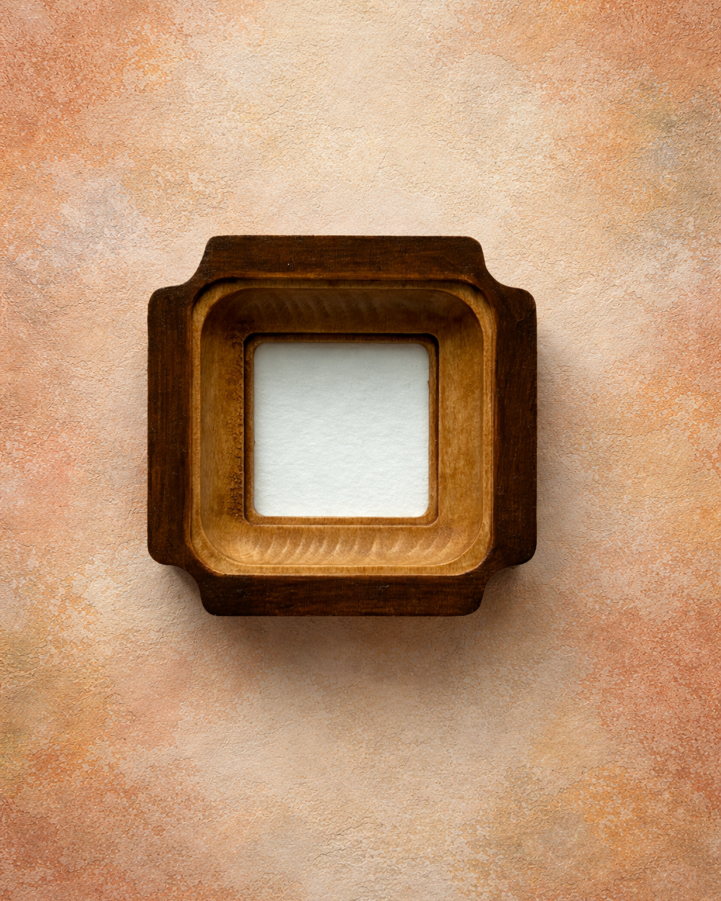 Wooden picture frame on a textured beige background