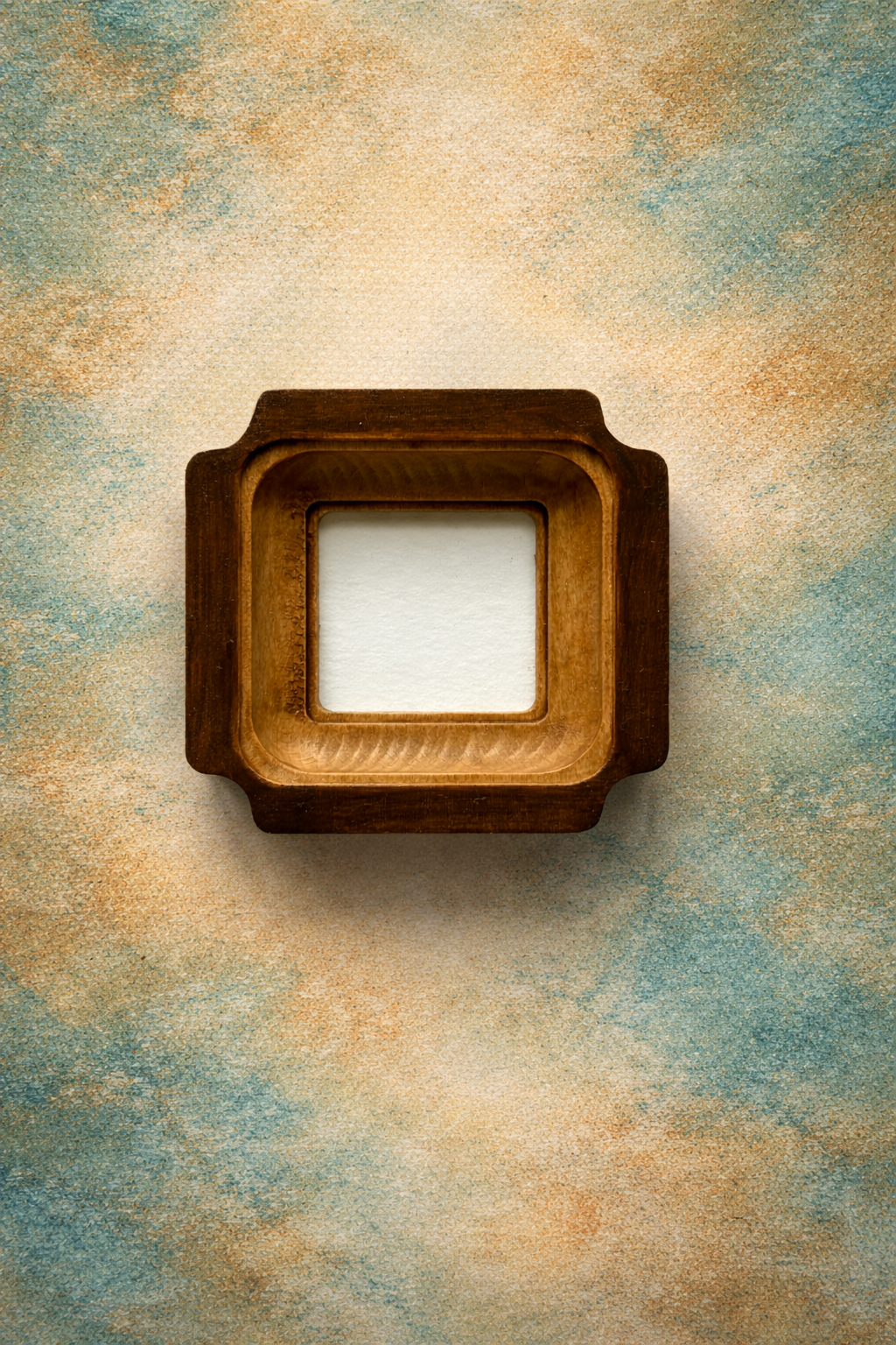 Wooden picture frame on a textured beige and blue background