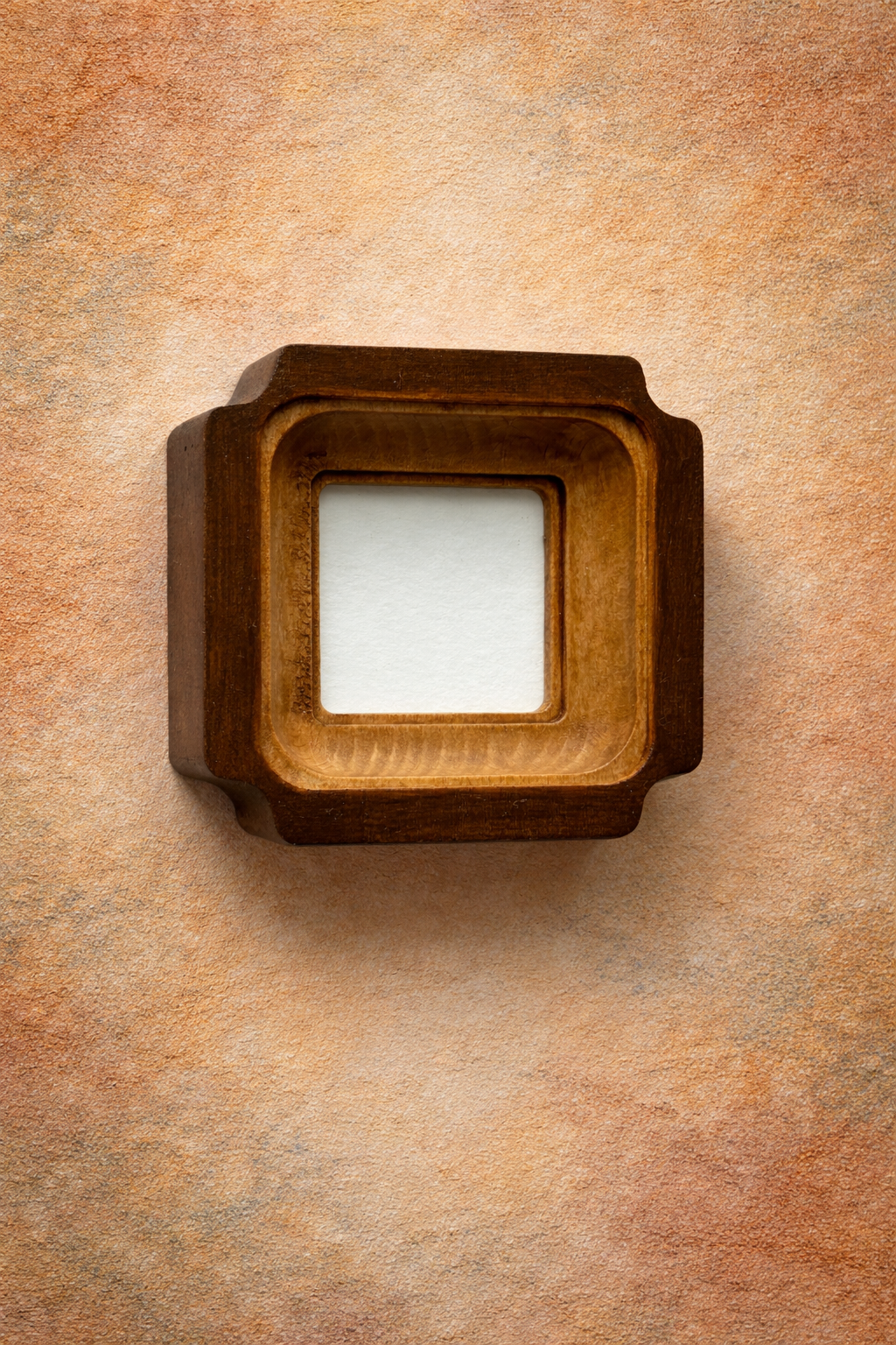 Wooden picture frame on a textured brown wall