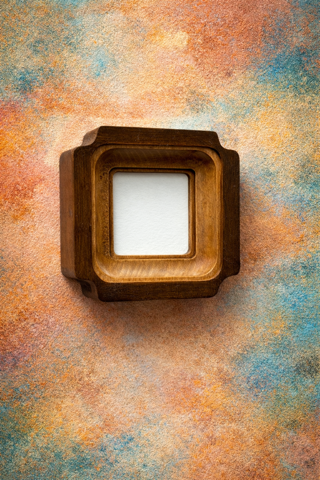 Wooden picture frame on a textured multicolored background