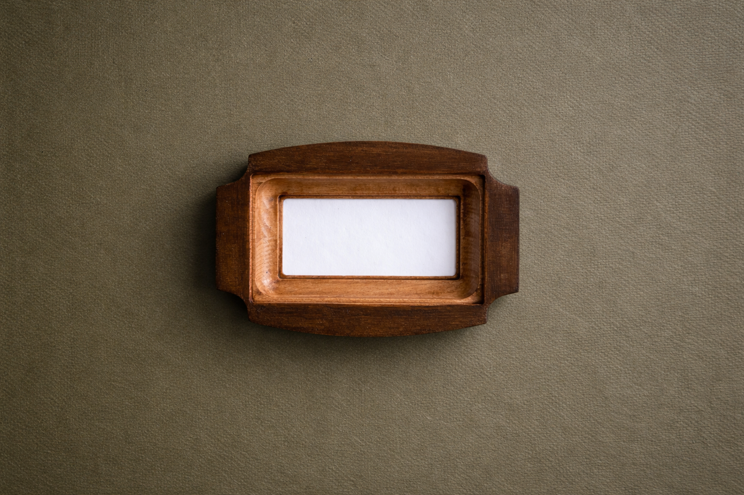 Wooden frame with a white card on a brown background