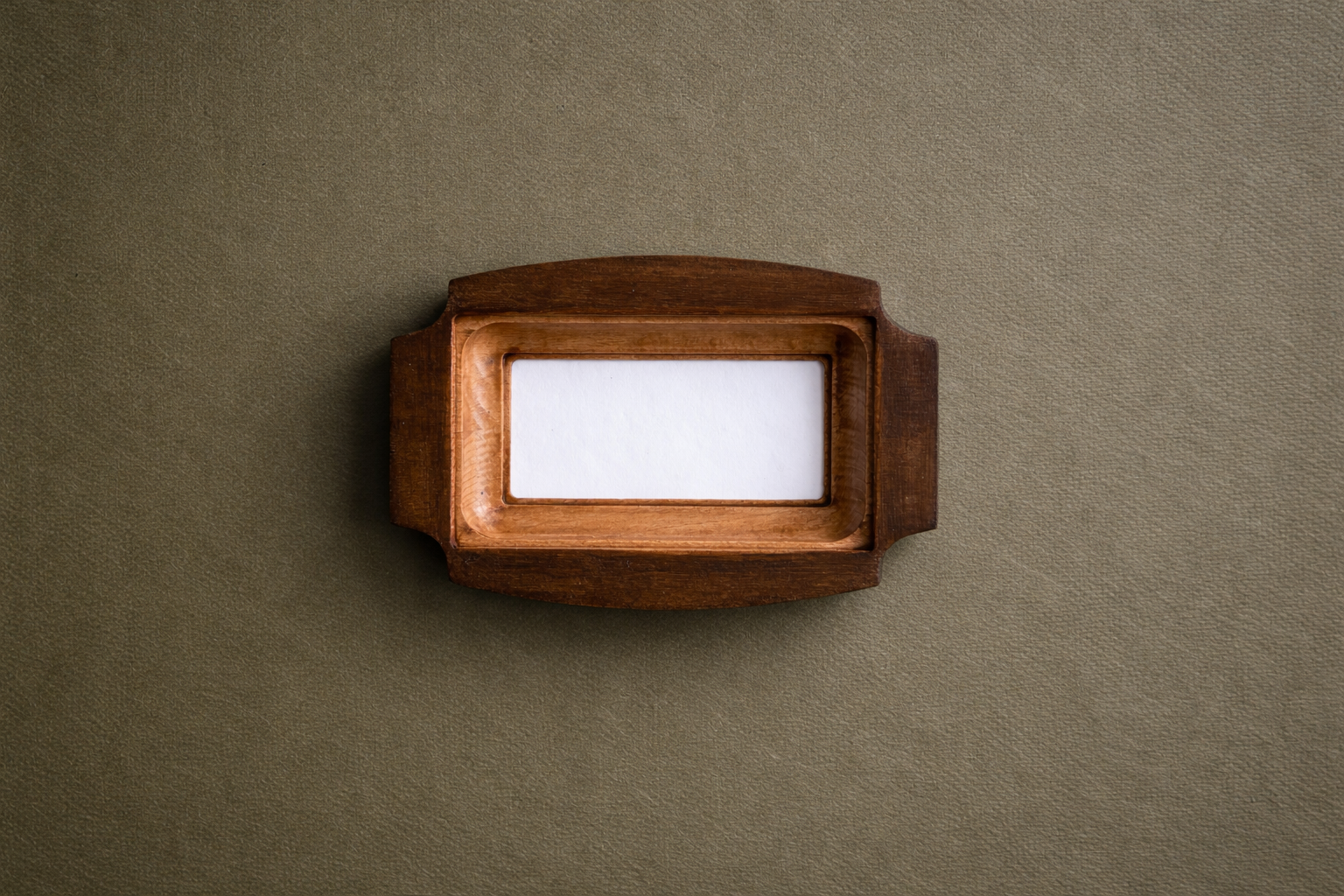 Wooden frame with a white card on a brown background