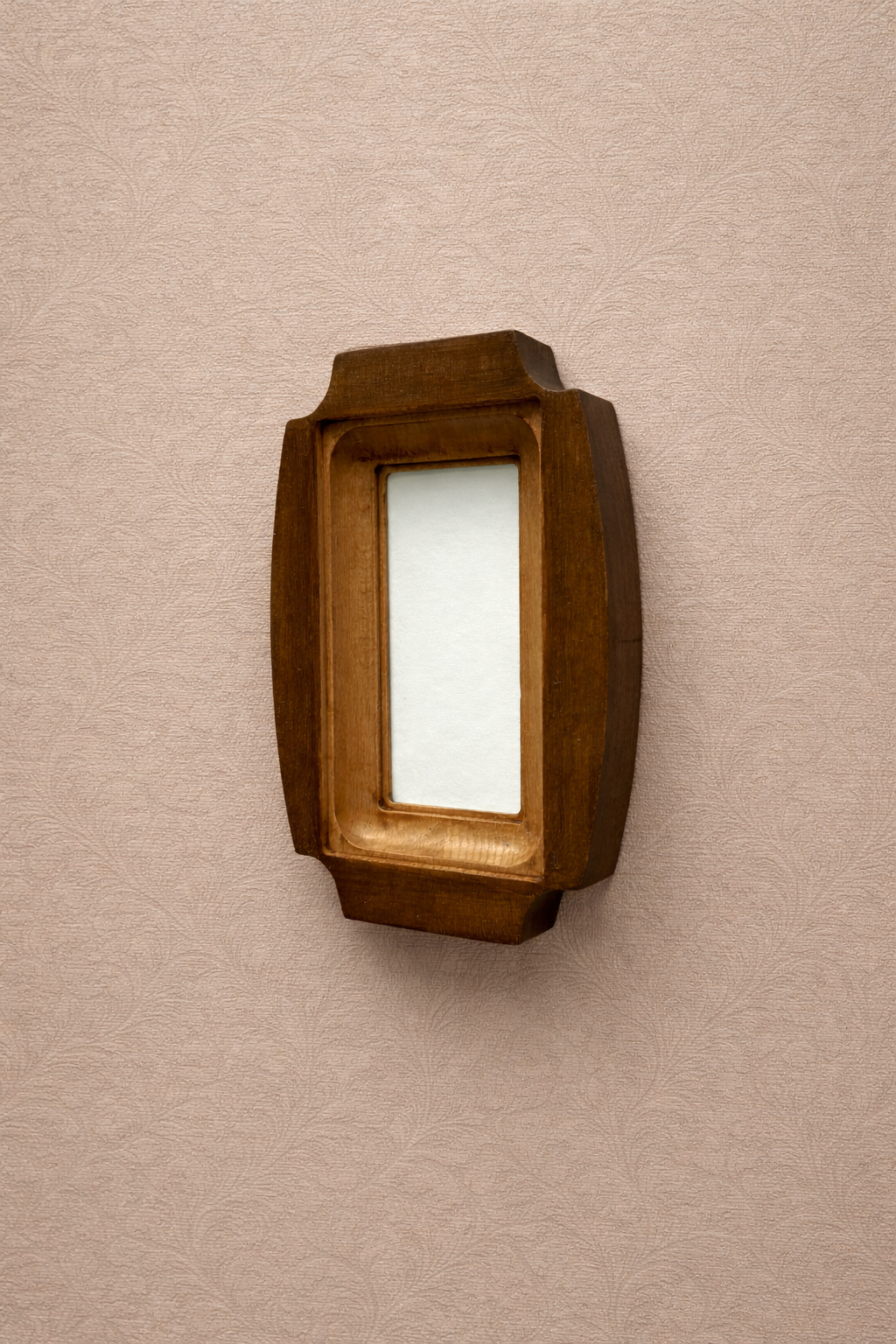 Wooden picture frame on a beige wall